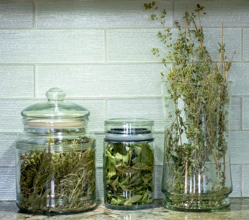 various herbs in glass jars