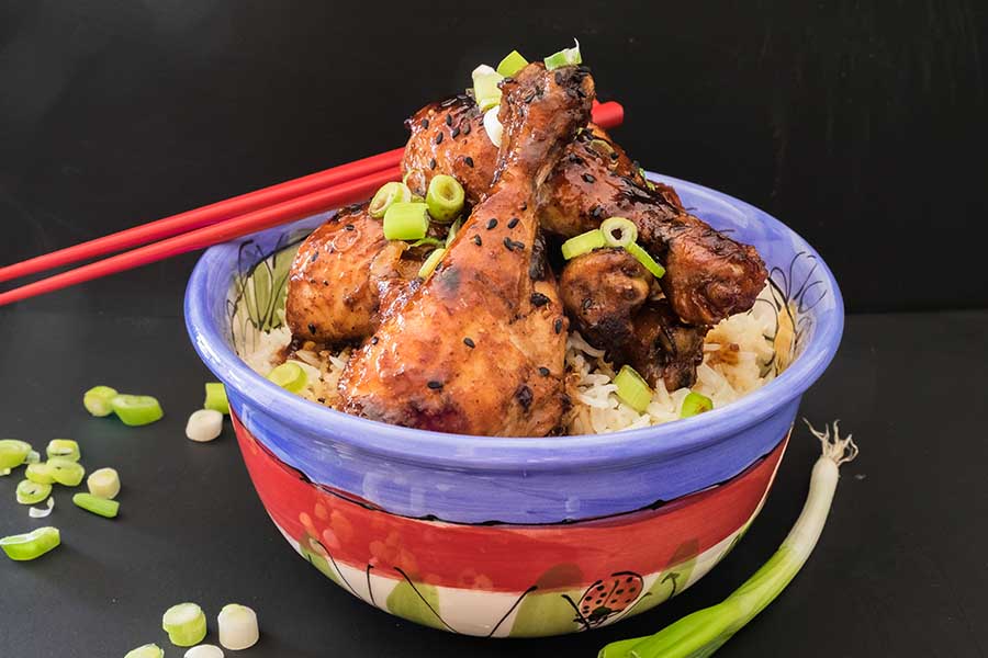chicken drumsticks in Peking sauce over rice