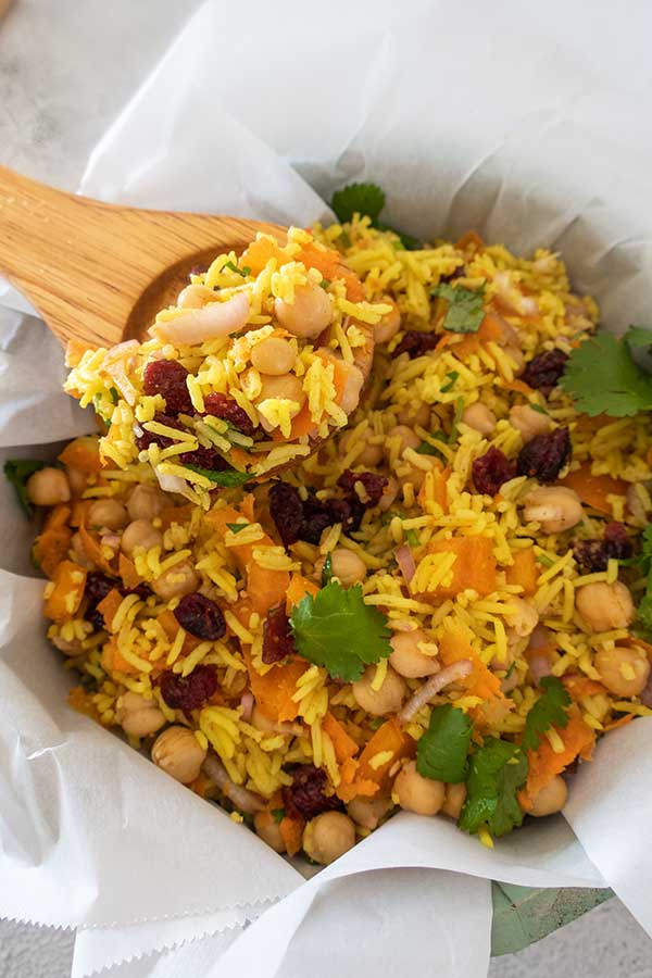 moroccan rice salad on a wooden spoon