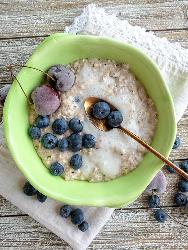 ginger bread overnight oats in a bowl with blueberries
