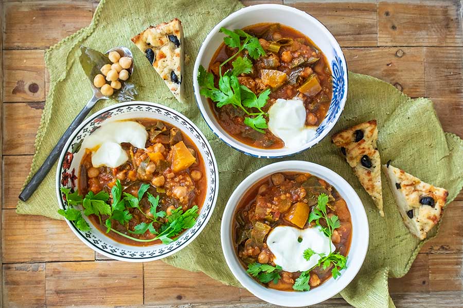 instant pot chickpea chili in 3 bowls with toppings
