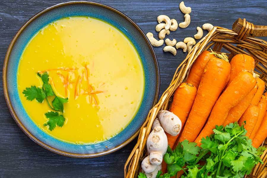 carrot ginger cashew soup in a bowl, vegan