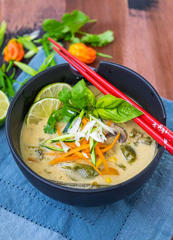 Thai chicken vegetable soup in a bowl with chop sticks