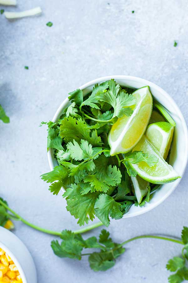 cilantro and lime wedges in a bowl