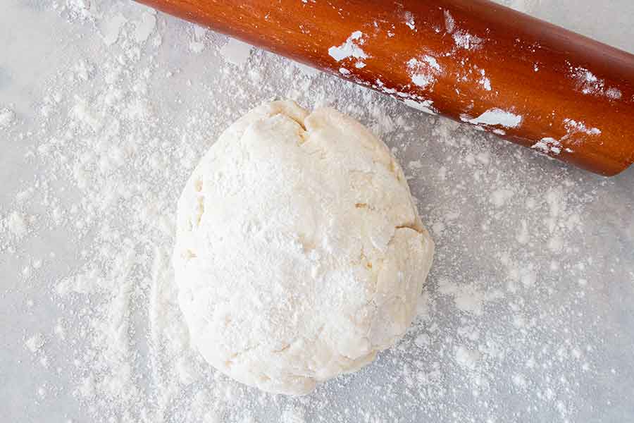 gluten-free yeast-free pizza dough with a rolling pin