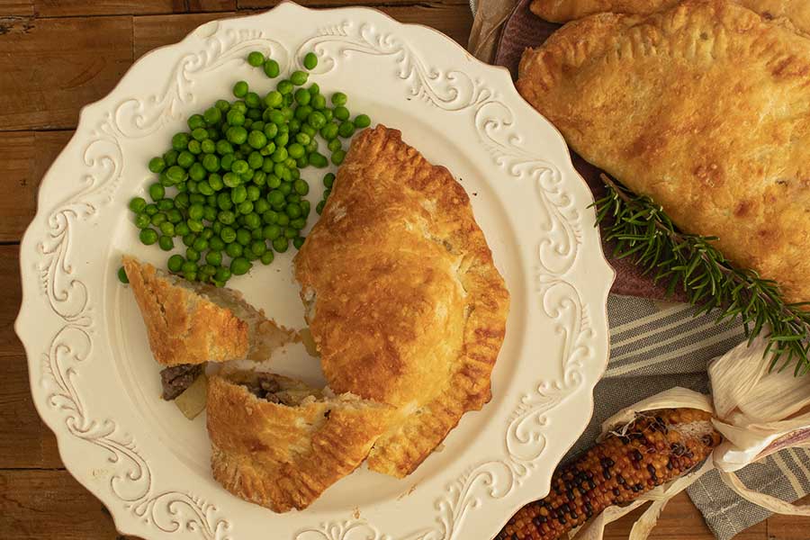 gluten free Cornish pasty on a plate with peas