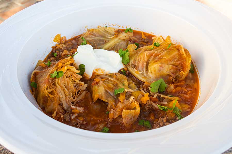 cabbage roll soup in a bowl topped with sour cream