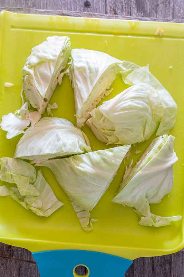 cabbage wedges on a cutting board