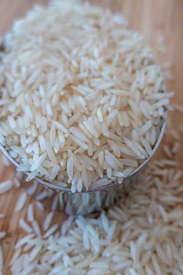 uncooked basmati rice in a measuring cup