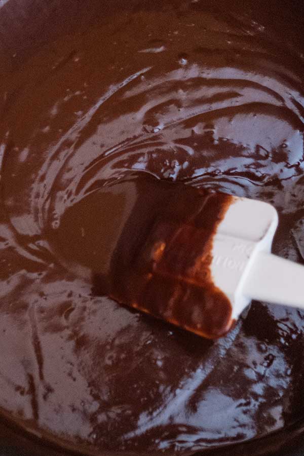 chocolate ganache in a bowl with a spatula