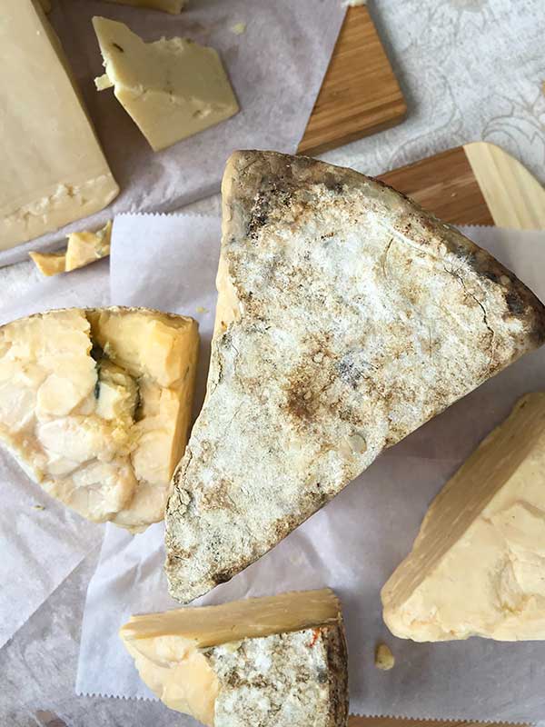 4 cheese varieties on a cutting board