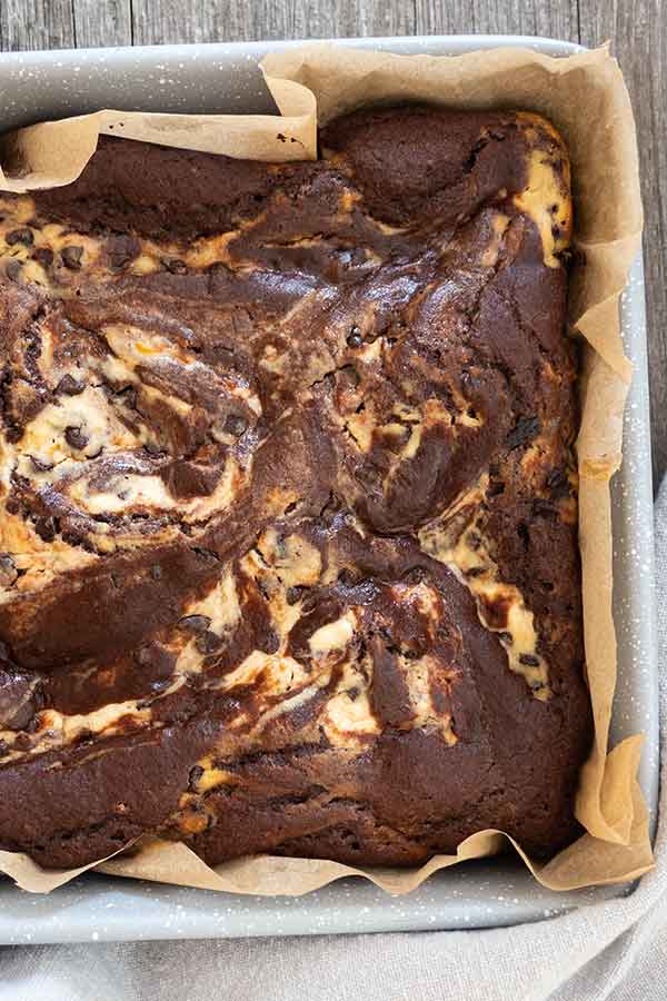 baked brownie with ricotta swirl in a square pan