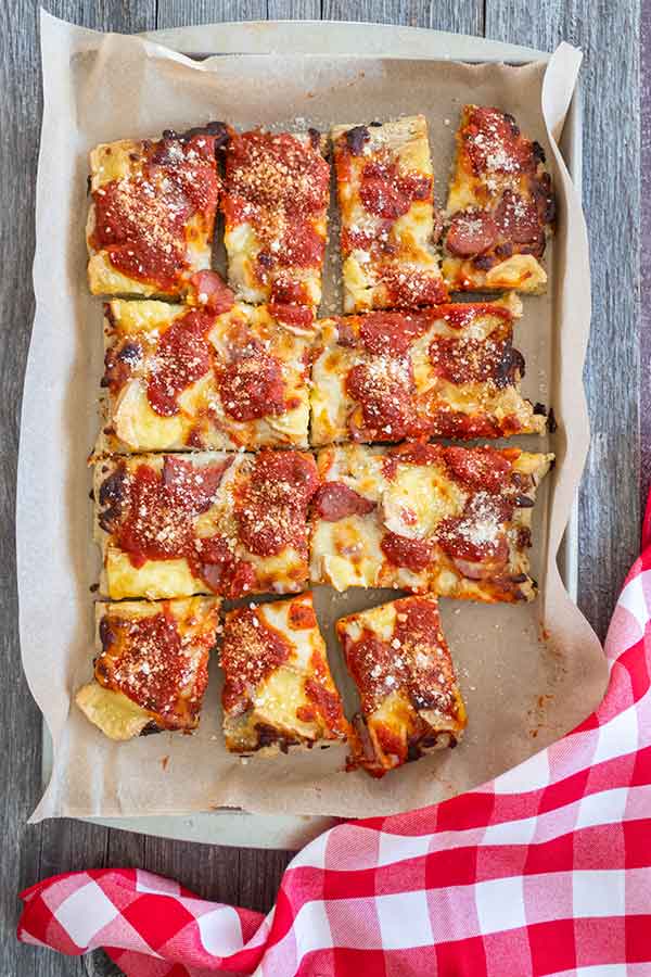 sliced gluten-free Detroit pizza topped with parmesan