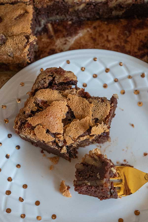 gluten-free fudgy brownie on a plate with a fork