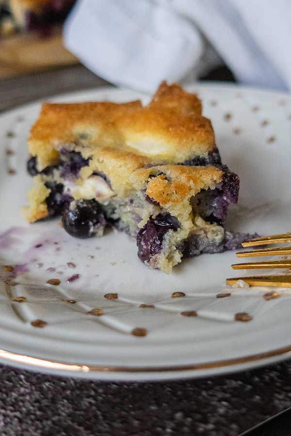a slice of keto butter cake with blueberries