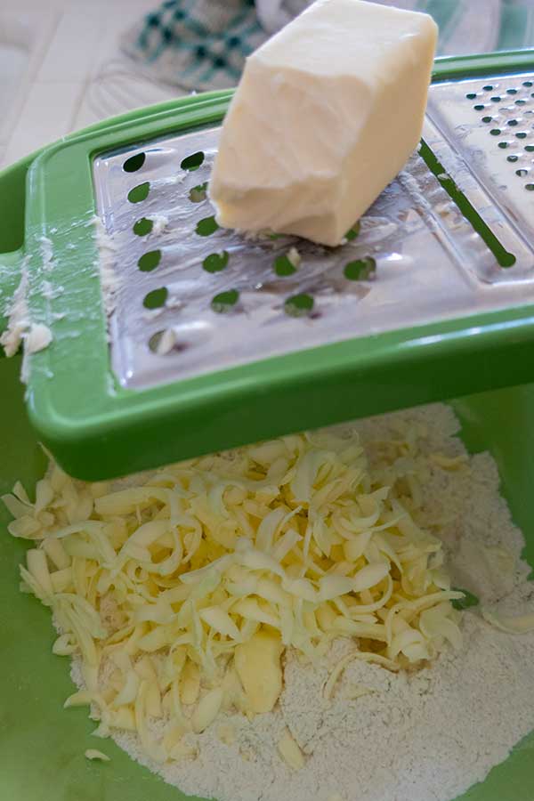 grating butter into flour