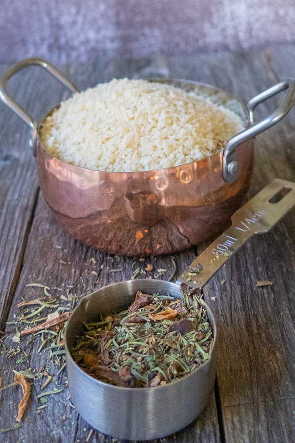 panko in a pan and herbs in a measuring cup