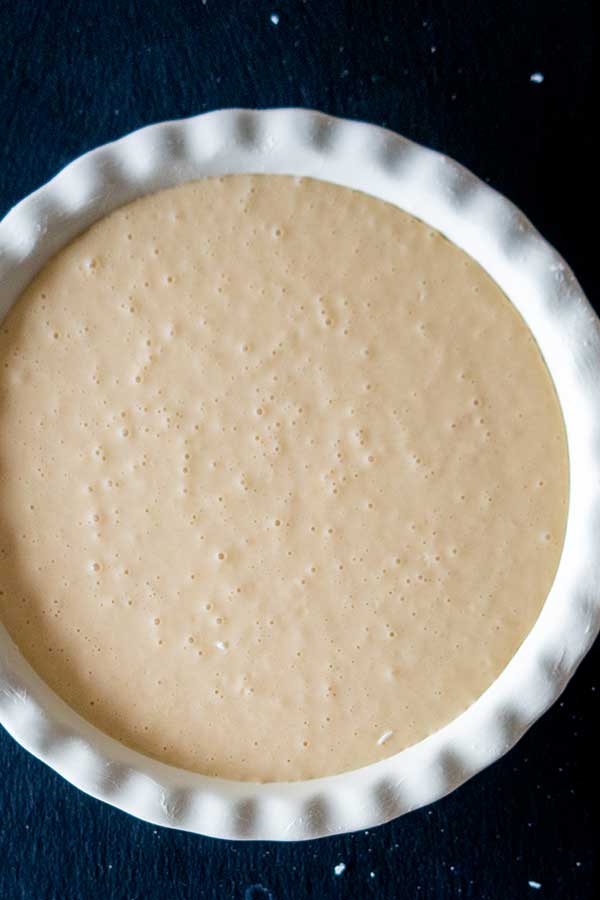 coconut batter for a pie in a pie dish