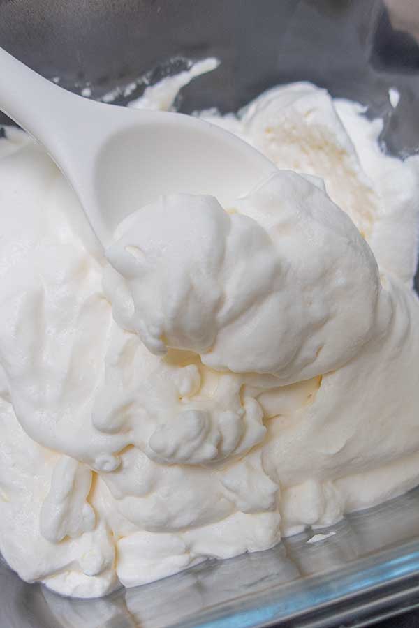 whipped cream in a bowl with a spoon