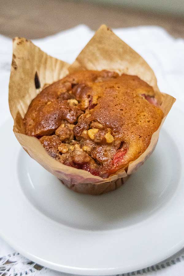 dairy-free strawberry muffin with pecans on a plate