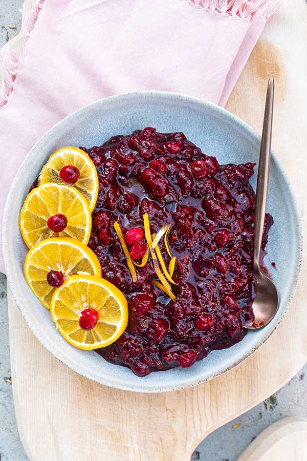 overview of cranberry sauce in a bowl with orange slices