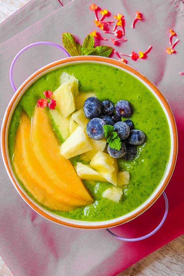 pineapple green smoothie bowl with toppings